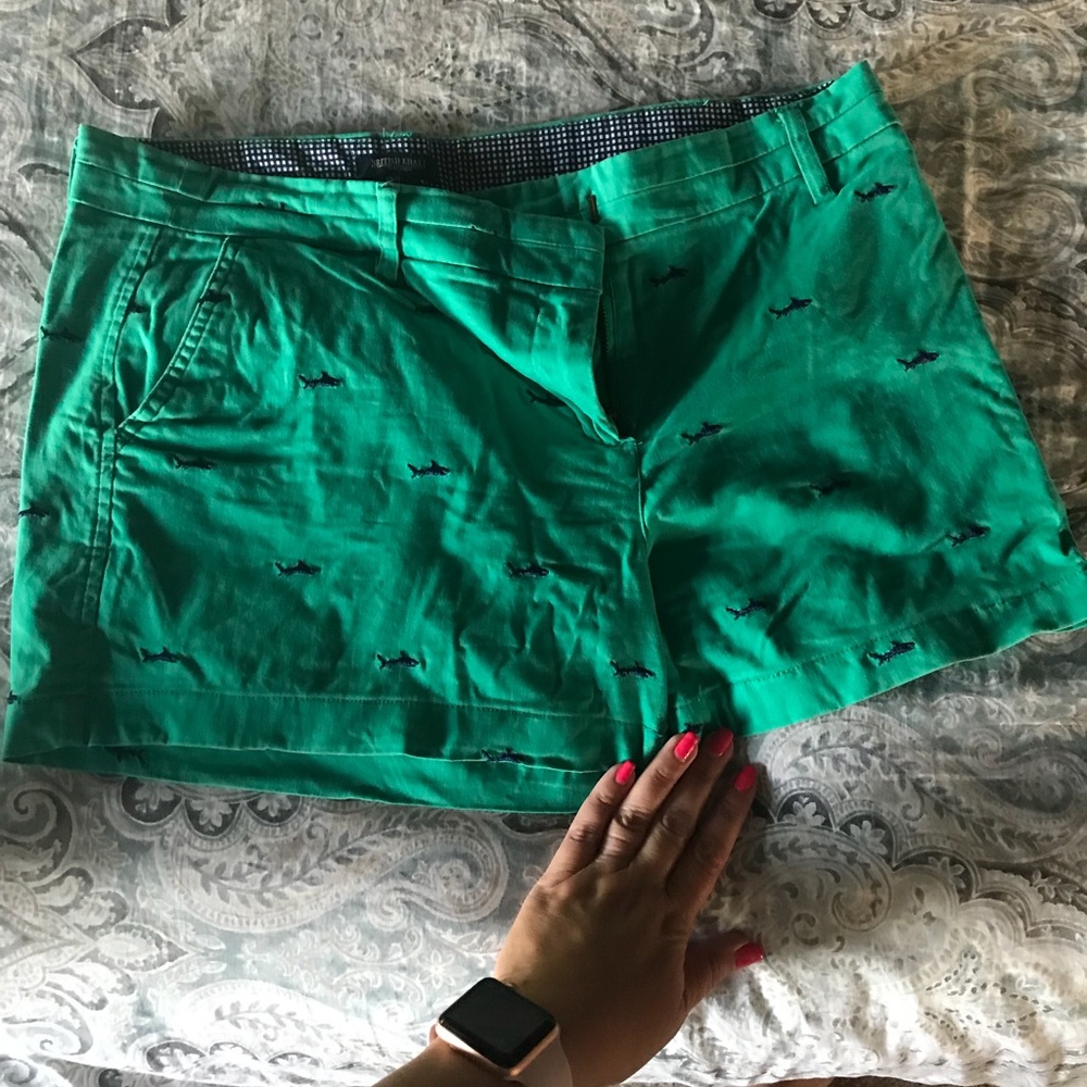 Green shorts with embroidered sharks